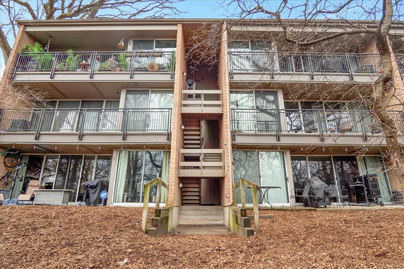 Front view of a three-story apartment building with balconies.