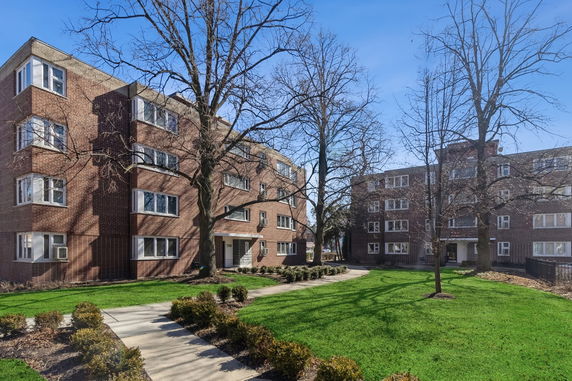 Front view of a multi-story brick apartment building.