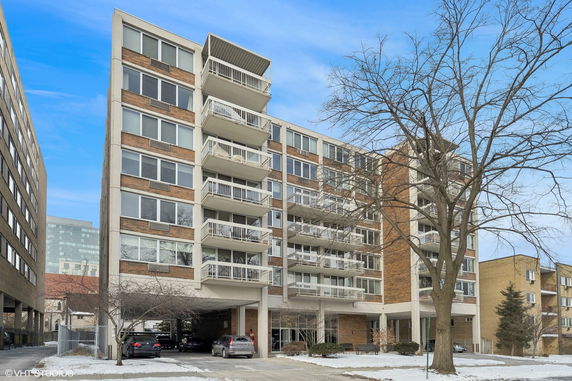 Front view of a multi-story residential building with balconies.
