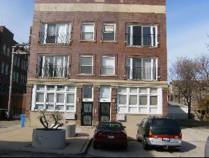 Front view of a multi-story brick apartment building.