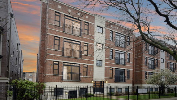 Front view of a multi-story brick apartment building.