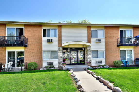 Front view of a two-story apartment building with balconies.