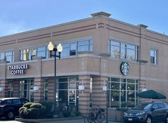 Front view of a two-story building housing a coffee shop.