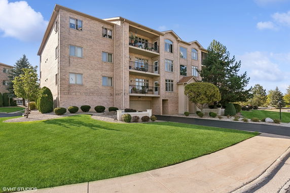 Front view of a multi-story residential building with balconies.