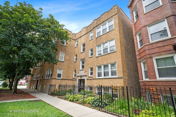 Front view of a multi-story brick apartment building.