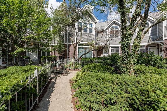 Front view of a two-story townhouse with brick and siding exterior.