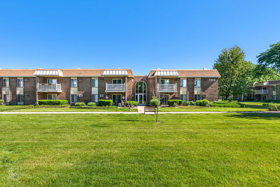 Front view of a two-story apartment building with balconies.