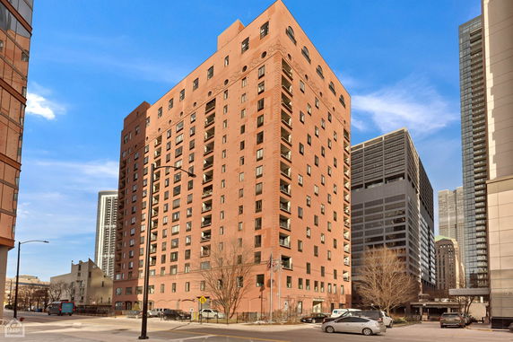 Front view of a multi-story apartment building in an urban area.