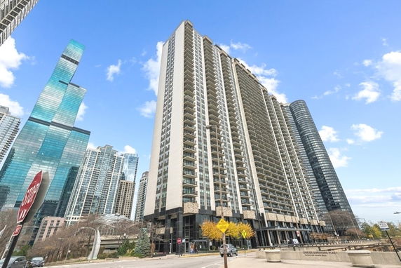 Front view of a high-rise residential building with multiple balconies.