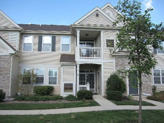 Front view of a two-story house with a small balcony.