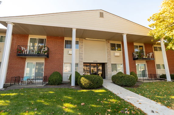Front view of a two-story residential building with balconies.