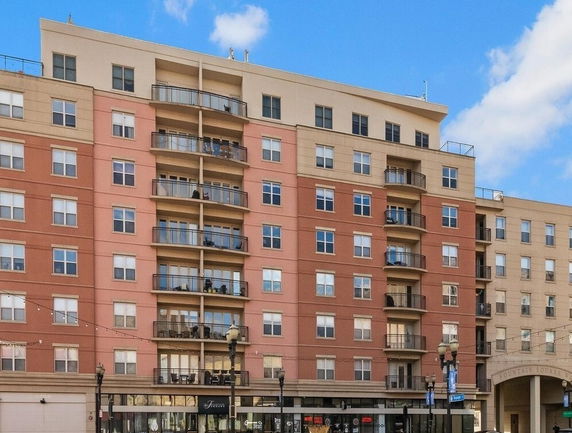 Front view of a multi-story apartment building with balconies.