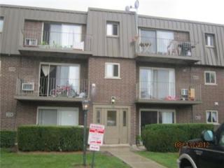 Front view of a three-story apartment building with balconies.
