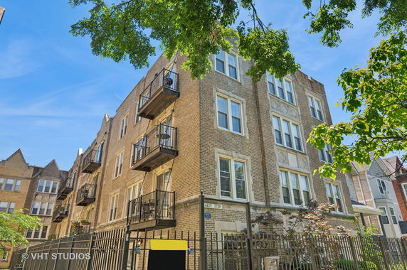 Front view of a multi-story residential building with balconies.