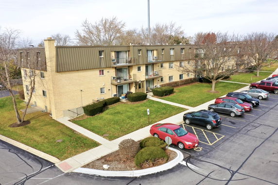 Front view of a multi-story apartment building with balconies.