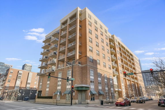 Front view of a multi-story residential building with balconies.
