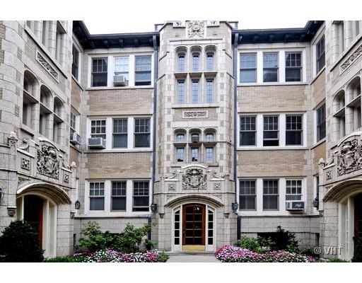 Front view of a multi-story building with ornate stonework and decorative elements.