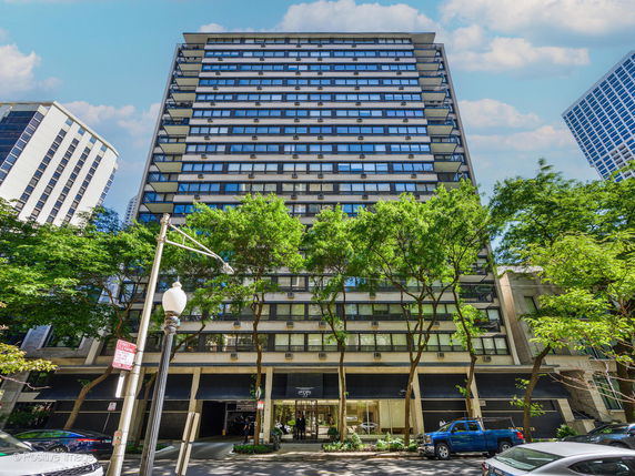 Front view of a multi-story building with large windows.