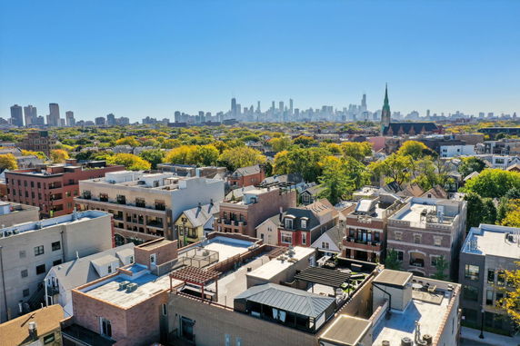 Panoramic view of a cityscape with residential buildings and a distant skyline.