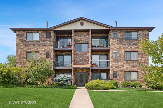 Front view of a multi-story brick apartment building