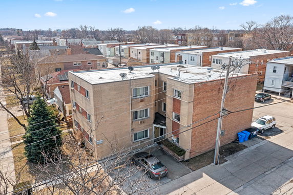 Aerial view of a multi-story brick apartment building.