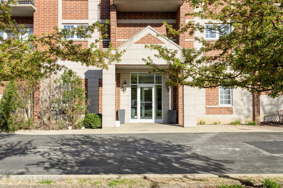 Front view of a building entrance with brick and stone facade.