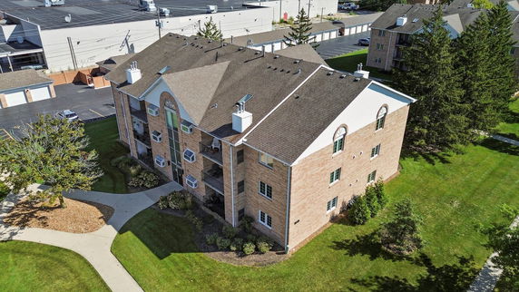 Aerial view of a multi-story brick apartment building.