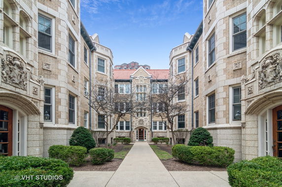 Front view of a multi-story building with ornate architectural details and symmetrical design.