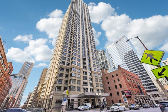 Front view of a tall skyscraper building with multiple windows.