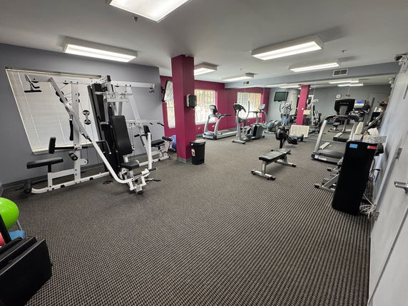 Indoor gym area with various fitness equipment.