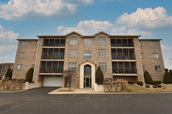 Front view of a multi-story residential building with balconies.