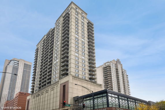 Front view of a high-rise residential building with multiple balconies.