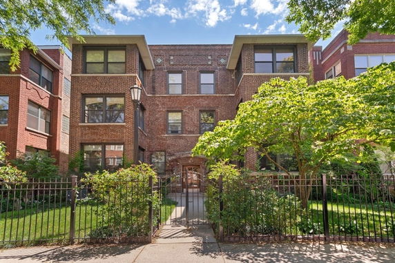 Front view of a three-story brick apartment building.