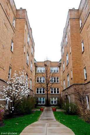 Front view of a multi-story brick apartment building.