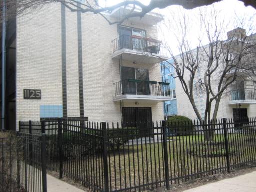 Front view of a multi-story apartment building with balconies.