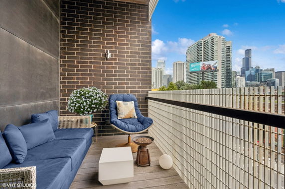 City skyline view from a balcony with outdoor seating.