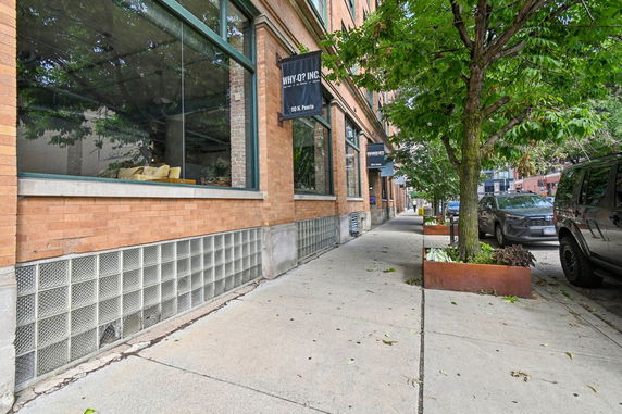 Front view of a building with large windows and signage.
