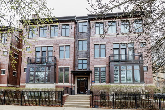 Front view of a multi-story brick apartment building.