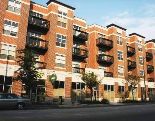 Front view of a multi-story brick building with balconies.
