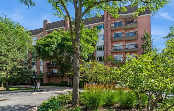 Front view of a multi-story apartment building with balconies.