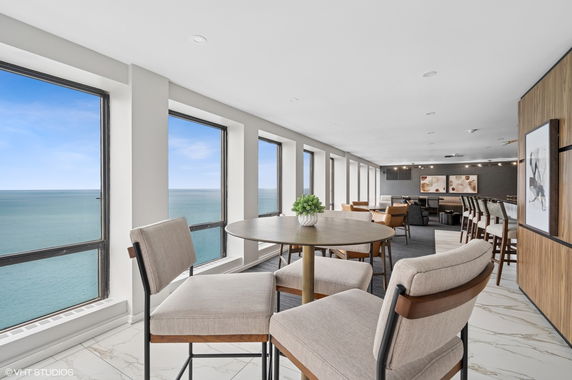 Spacious indoor area with seating and large windows offering ocean views.