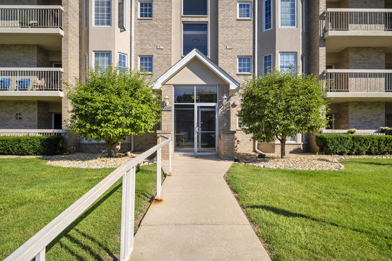 Front view of a multi-story residential building with balconies.