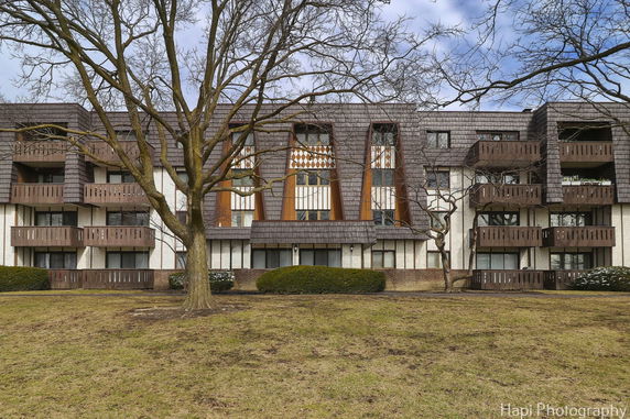 Front view of a multi-story residential building with balconies.