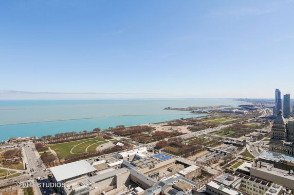 Panoramic view of a cityscape with a waterfront and buildings.