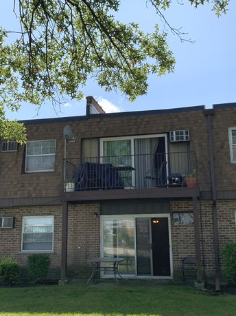 Front view of a two-story brick building with balconies.