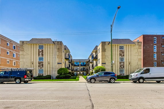 Front view of a multi-story brick apartment building.