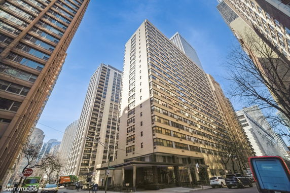 Front view of a tall multi-story building in an urban environment.