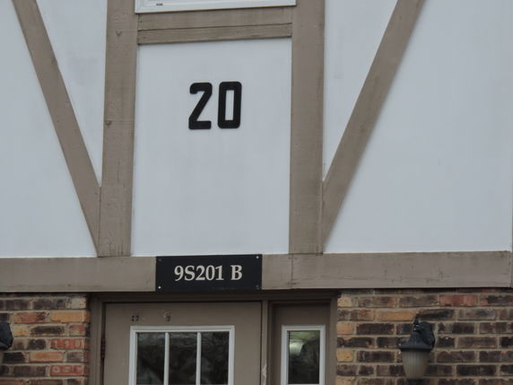 Front view of a building with a number 20 and a sign reading 9S201 B.