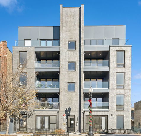 Front view of a multi-story building with balconies.