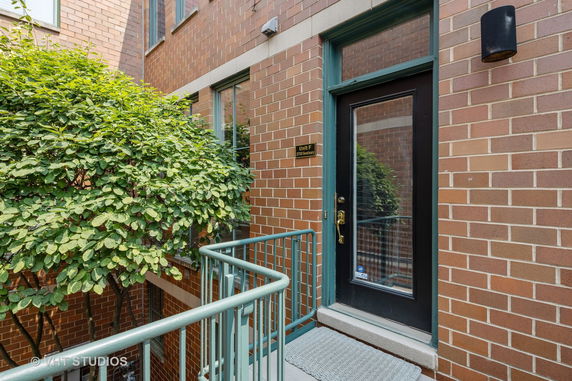 Entrance view of a brick building with a glass door.